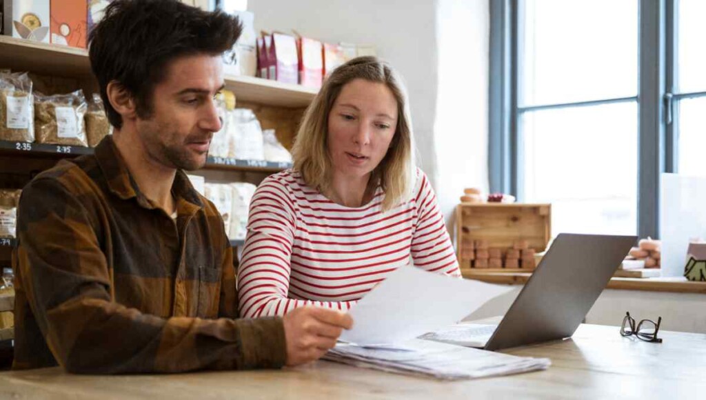 Small business owners reviewing documents for Washington PFML