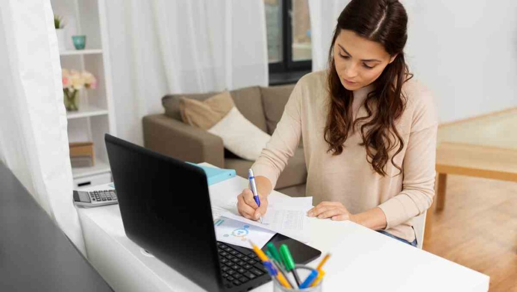 Small business owner working on bookkeeping using QuickBooks AI features.