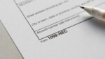 Close-up of a blank Form 1099-NEC with a pen resting on it, illustrating the 1099-NEC threshold change for 2026